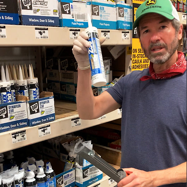 Brian showing a container of caulking