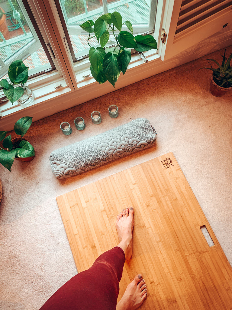 bamboo yoga board rest on a carpet near a window (don't forget the pedicure)